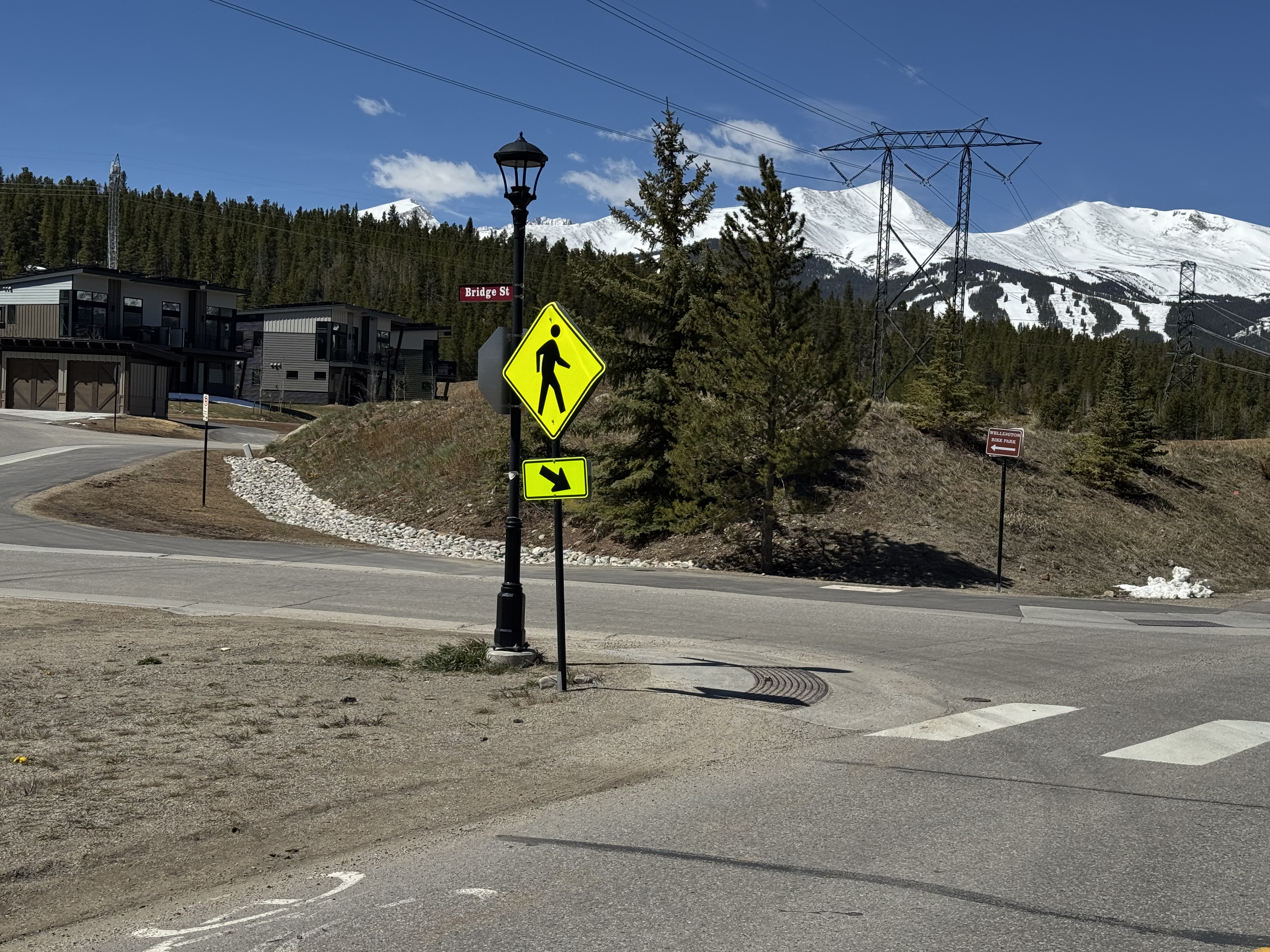 Turning off Wellington Road onto Bridge Street, with the Bridge St sign and Breckenridge ski area in the distance