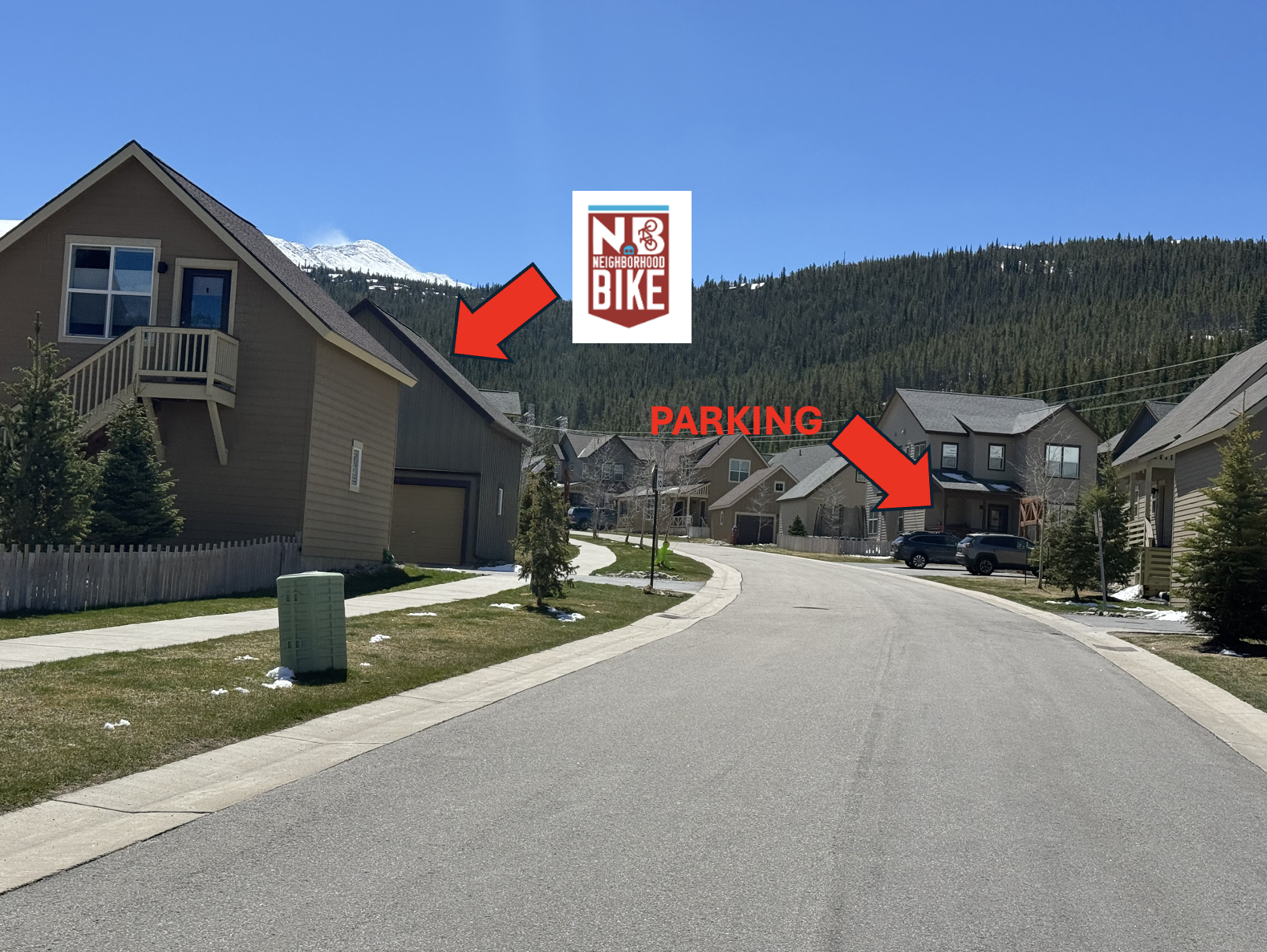 Approaching the shop — green siding with purple trim on the left, parking on the right